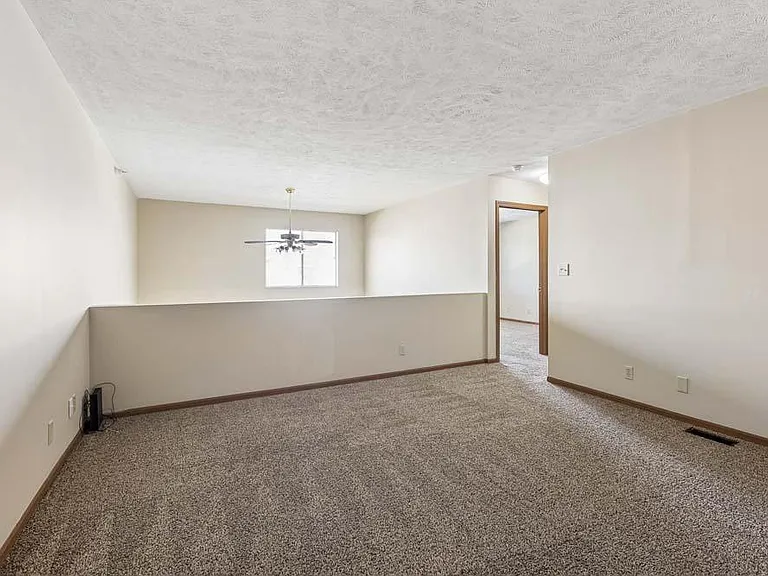 The spacious loft offers a flexible retreat with an open design that's perfect for a home office, lounge, or creative space.