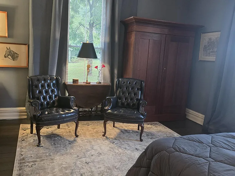 Second view of sitting area and wardrobe, bed.