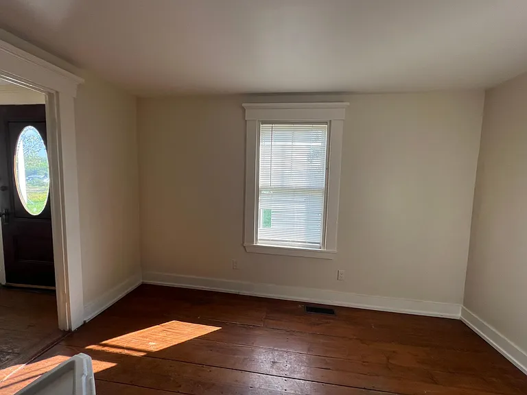 Living room with wood stove off entry hall