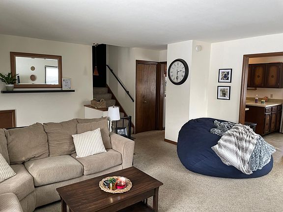 Main living level with entrance to kitchen adjacent to stairs, entry to dining room, right of frame.