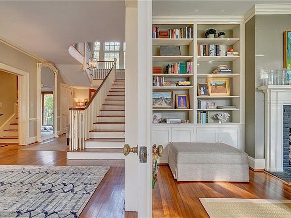 Foyer transitioning to living room--gorgeous built-ins and trim work (ceiling height mirror in foyer is built-in and original to home)