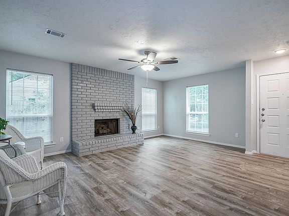 ANOTHER VIEW of the FAMILY ROOM with NEW CEILING FAN / Bowl Light, LED NEW LIGHT at the Front Door.
Freshly painted including the Fireplace !!