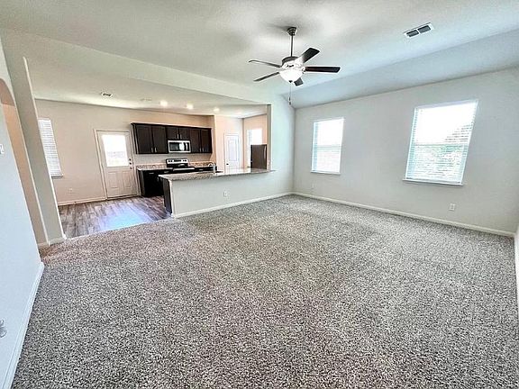 Lot's of natural light in this living room that opens up to kitchen area