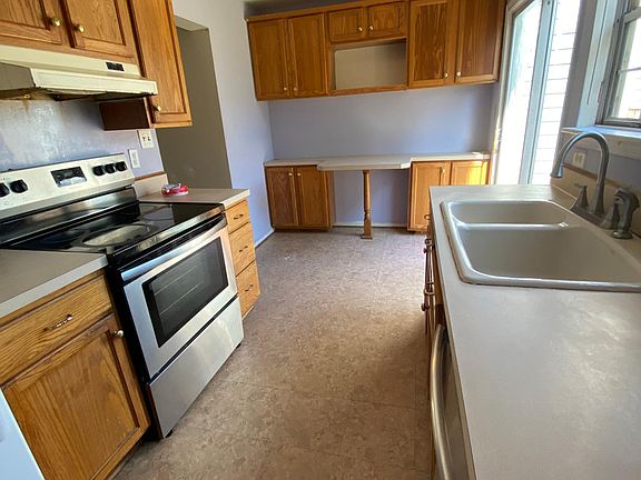 Kitchen has extra cabinets and small eat in bar height counter
