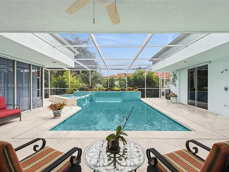 Screened pool and spa surrounded by the home