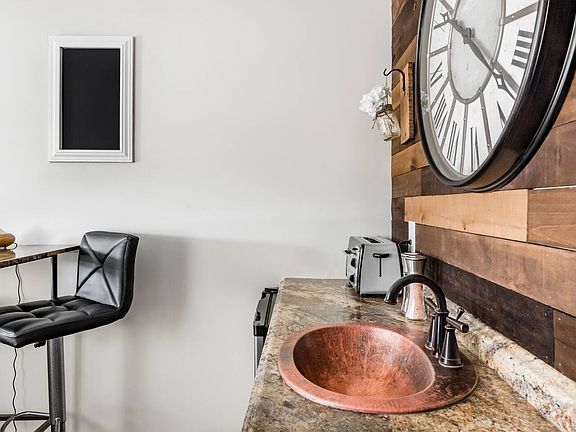 The kitchenette is thoughtfully designed and fully furnished, featuring a sink, dishwasher, microwave, and all essential utensils, perfect for convenient, everyday living.