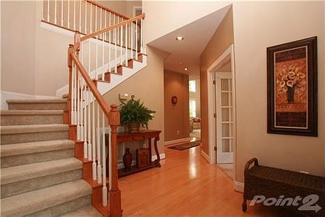 What a nice foyer with lovely hardwood floors. This is a great place for your favorite decoration or