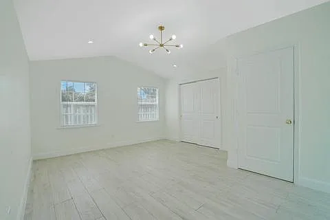 Primary Bedroom 2, wall-to-wall closet and bathroom door. Windows face front yard