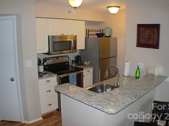 Upgraded kitchen fully stocked with granite counters and stainless appliances
