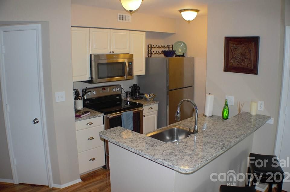 Upgraded kitchen fully stocked with granite counters and stainless appliances