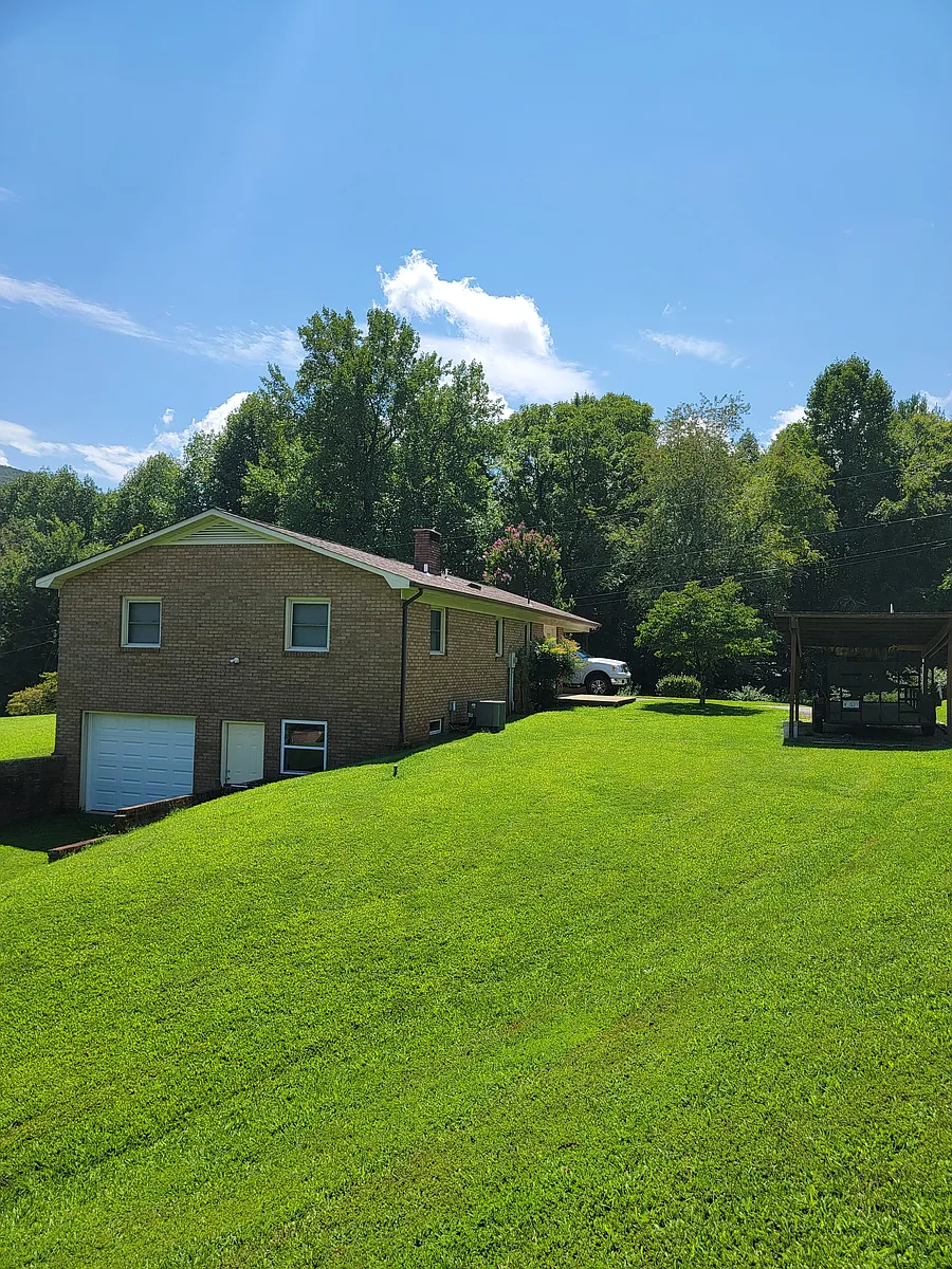 Back of home with full basement, new door, garage door, and windows. - 5787 John Icard Rd