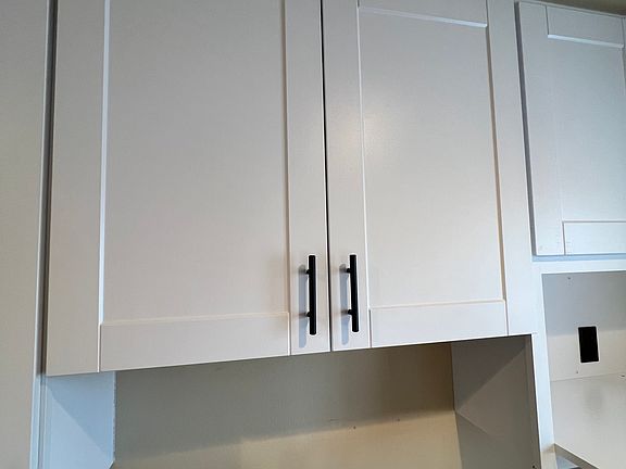 New kitchen cabinets, stainless steel sink and faucet.