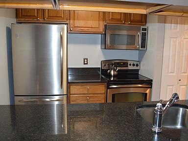 Kitchen with stainless steel appliances and granite counters.