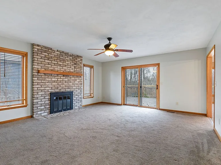 Family room with gas fireplace offering both additional warmth and