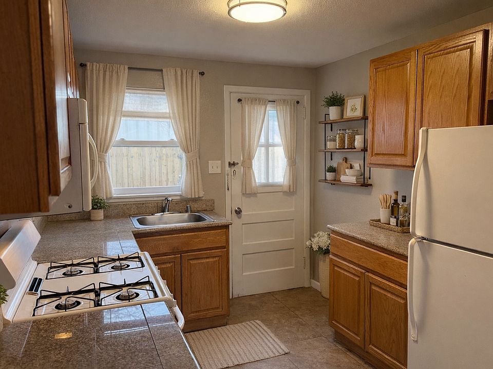 Inviting kitchen with warm wood cabinetry and direct access to the backyard_perfect for indoor-outdoor living.