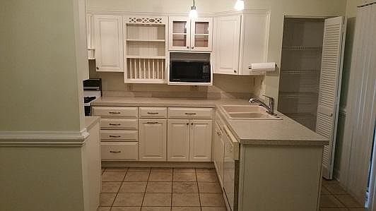 Kitchen, microwave, dishwasher, pantry, blinds on sliding door