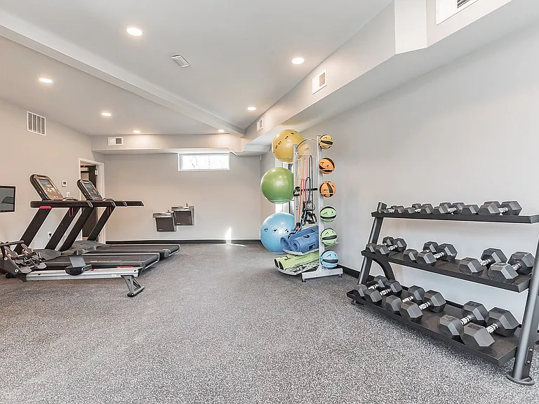 Elevate your workout experience with this well-appointed home gym.