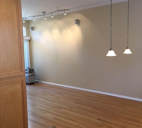 Dining area next to kitchen with upgraded lighting
