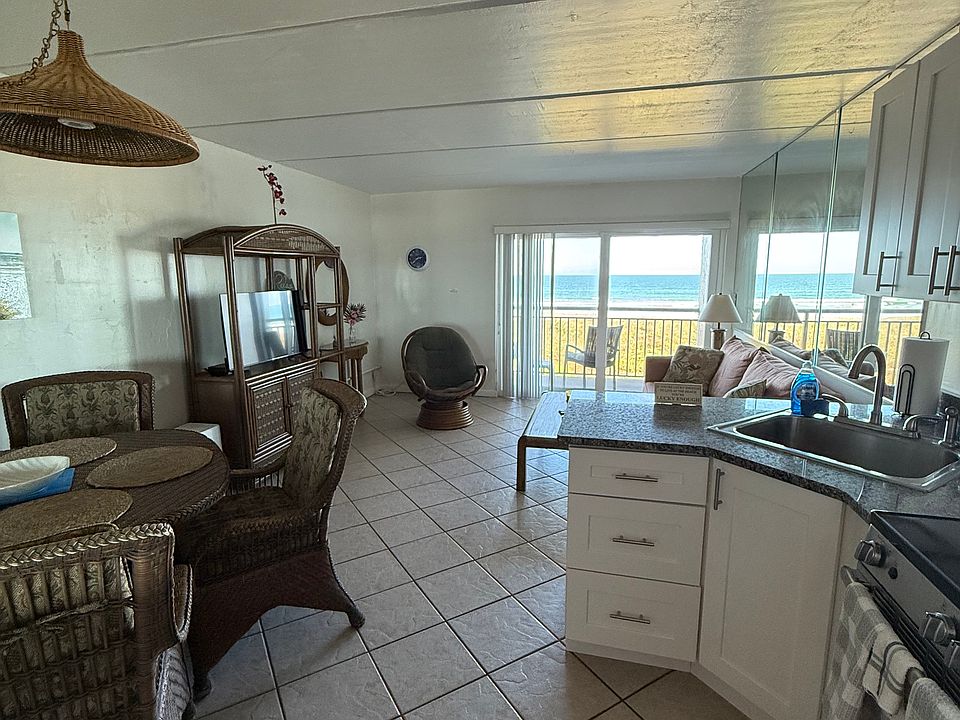 Main living area with pull out queen sleeper sofa, dining and kitchenette