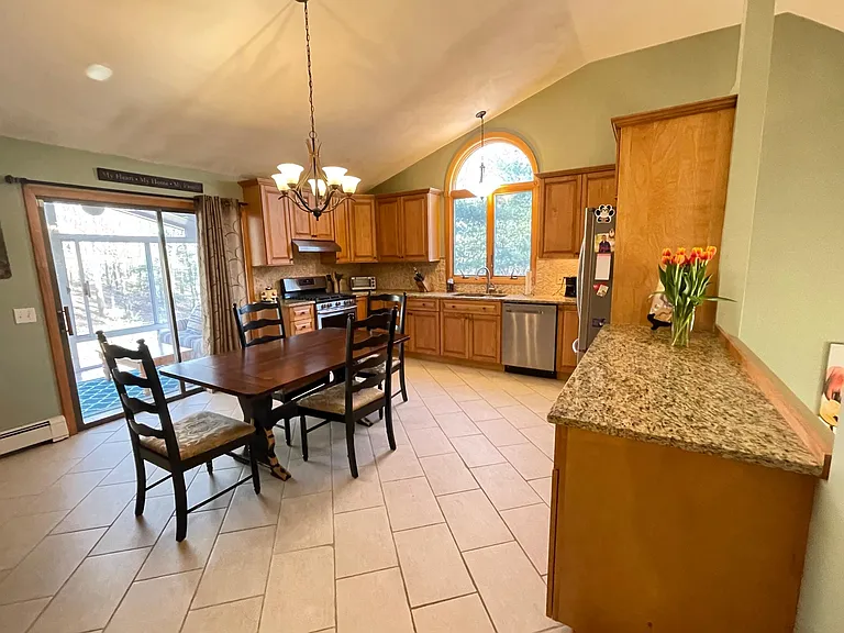 Chef's eat-in kitchen with gas stove and granite countertops as well as custom cabinets aplenty!