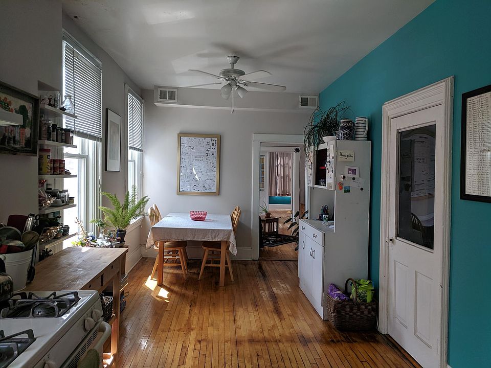 This is looking from the kitchen through the dining room to living room to bedroom 1, the door on the right is to the 2nd bedroom.