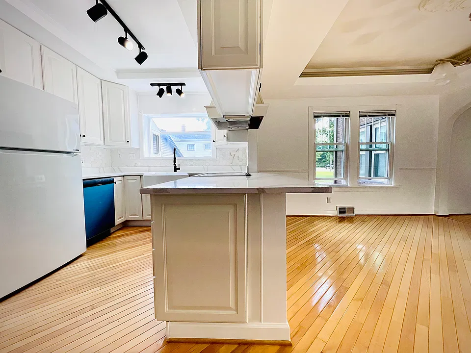 Upgraded Kitchen with additional seating. Allow an overhang on the quartz slab countertops so knees fit comfortably when seated on standard bar or counter stools.