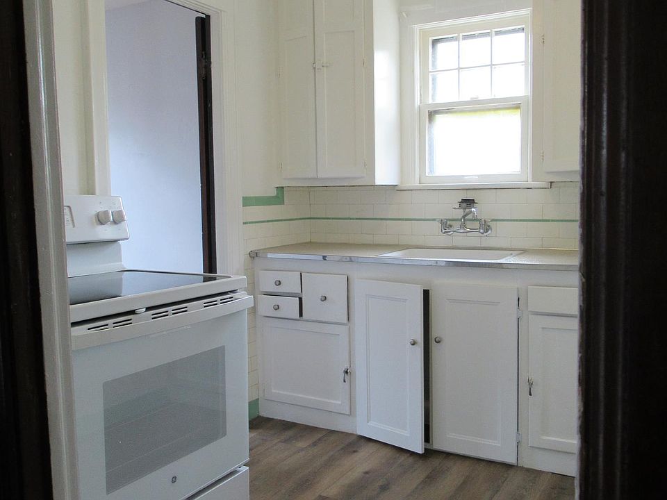 Kitchen, viewed from door into hallway, showing stove and sink area