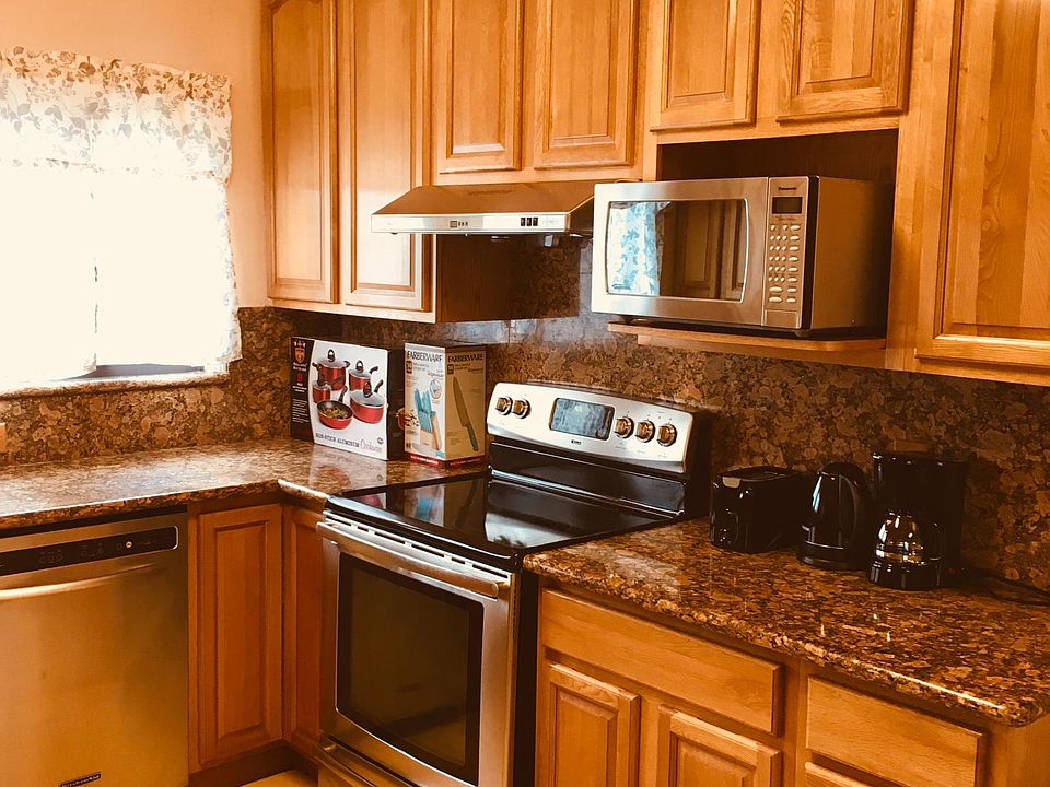 Kitchen with dishwasher, microwave, electric range, and refrigerator