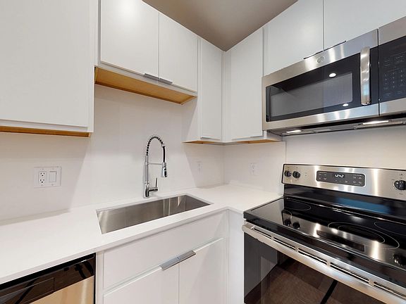 Kitchen with Stainless Steel Appliances, Farmhouse Sink, & Designer Cabinetry