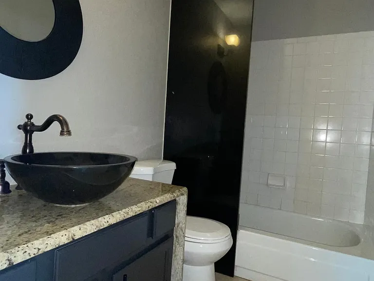 UNFURNISHED. Guest bathroom. Granite countertop, partition wall and bow sink.