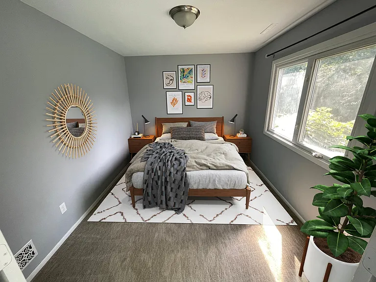 Lower level bedroom behind french doors. Window outlooks to the backyard, shed, and beyond that is wildlife.