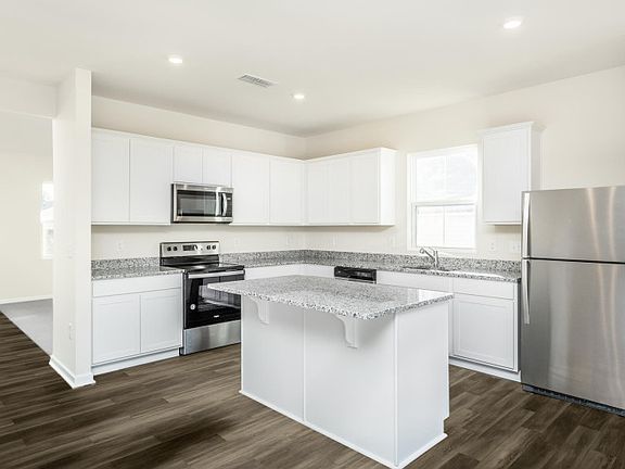 Package A Kitchen with beautiful white cabinets and granite countertops.