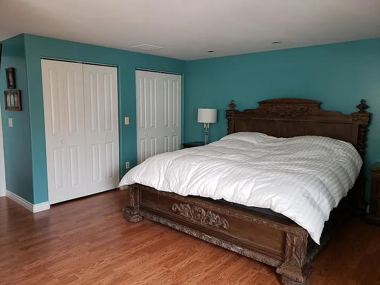 Master bedroom is huge. This king size bed still allows for side tables on both sides with room to spare.