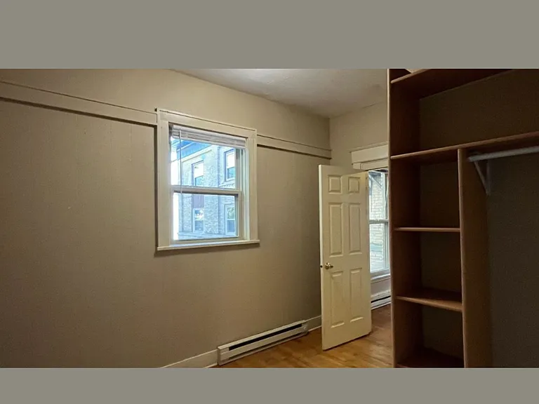 Bedroom C offers beautiful hardwood floors and a peaceful view of the backyard, creating a comfortable and inviting space. It features a built-in storage system to help keep everything organized and clutter-free. Enjoy personalized comfort with individual