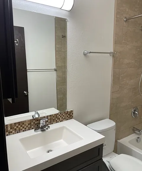 Vanity in bath with Tile tub enclosure