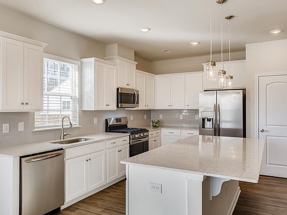 Spacious, bright kitchen with tons of storage.