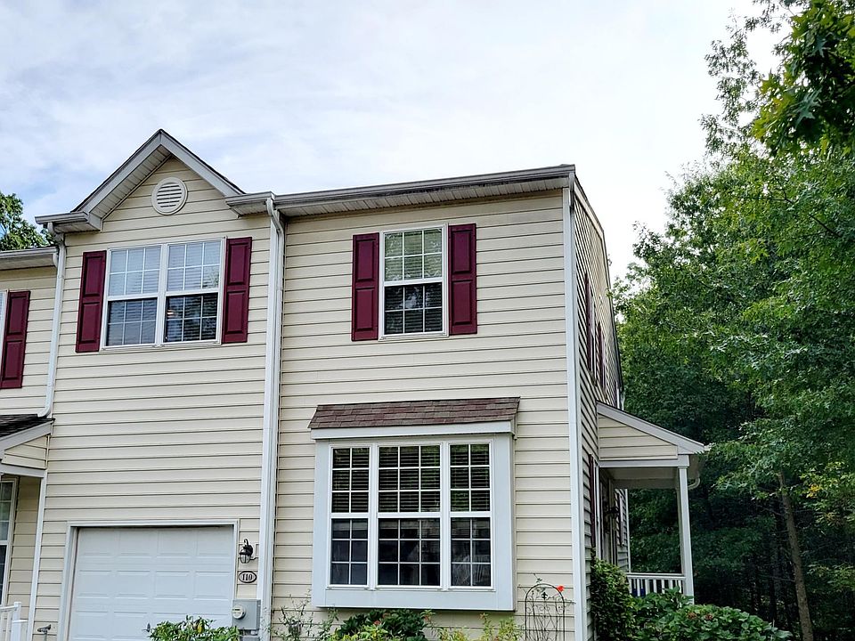 Private end unit with garage, driveway, and shared parking areas