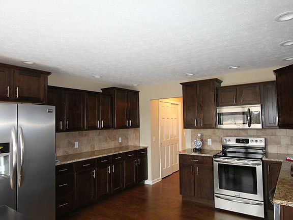 Brand new & modern kitchen with granite counter tops and stainless steel appliances.