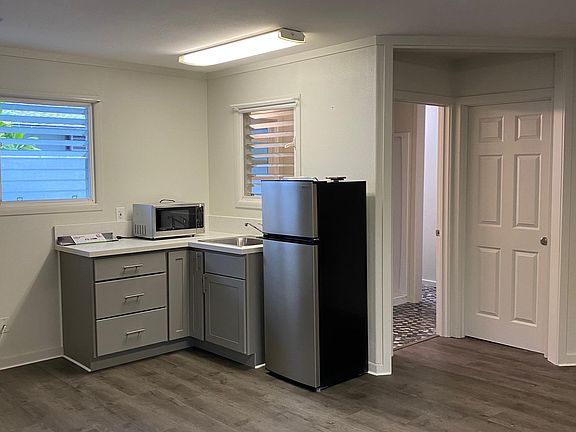 Brand new refrigerator, microwave and dual hot plate. There is now a shelf above the counter for the microwave.