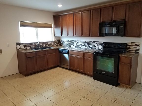 Clean kitchen with sliding windows to back yard