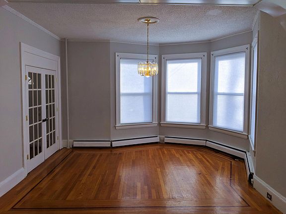 Living room at front of house. French doors open to front door hallway.