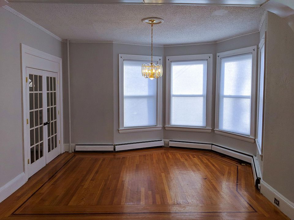 Living room at front of house. French doors open to front door hallway.