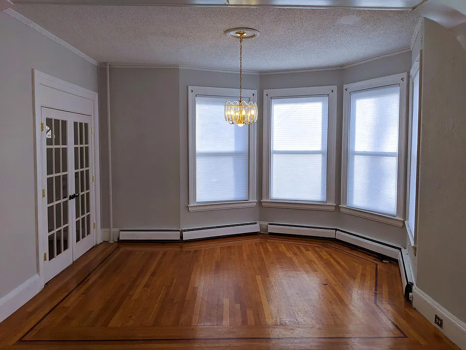 Living room at front of house. French doors open to front door hallway.
