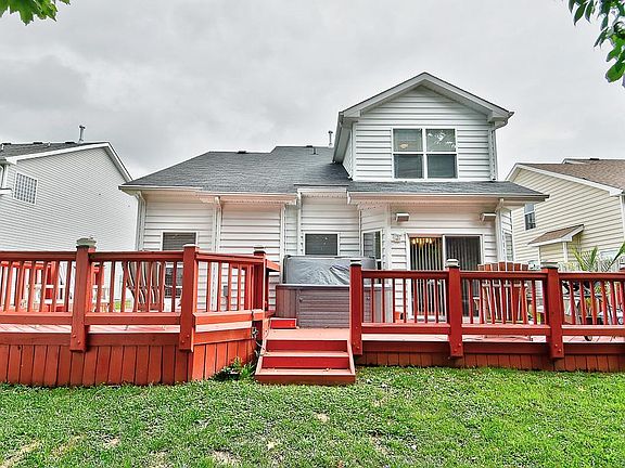 Back of the house with large stained solid wood deck.