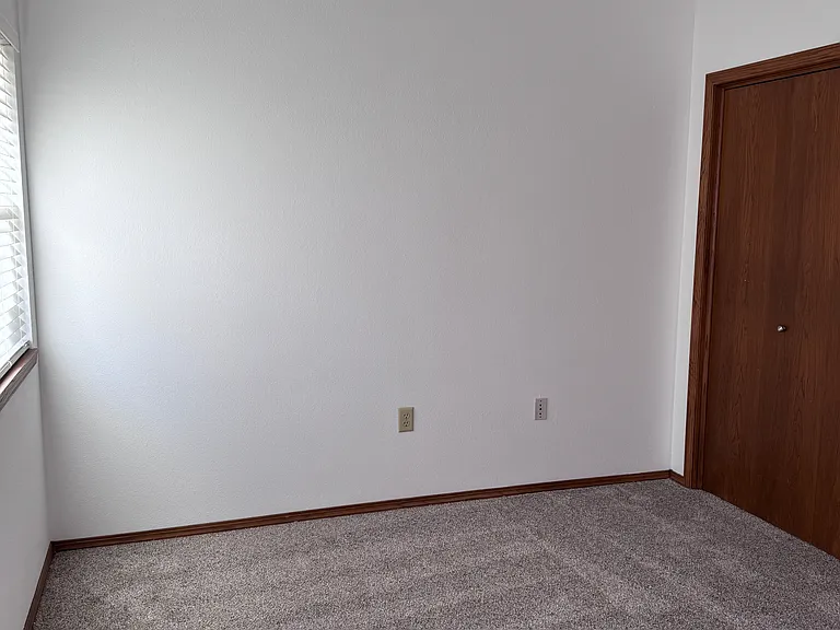 Larger bedroom with vaulted ceiling and back patio door. And large closet.