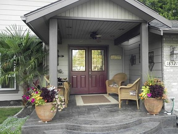 The gorgeous covered porch with stamped concrete provides a glimpse of the quality home that lies beyond.