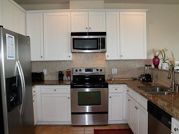 Kitchen with stainless steel appliances & granite counter tops.