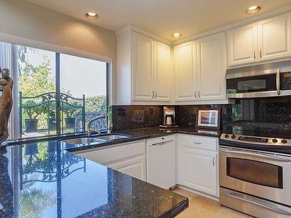 Kitchen with granite counter tops and new LG refrigerator