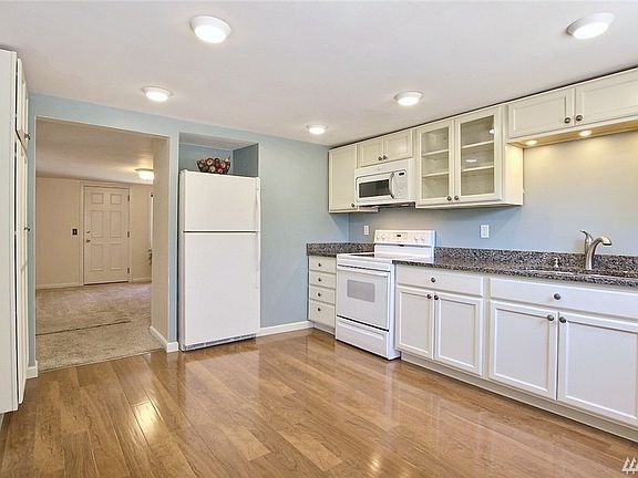 Built-in pantry and recessed fridge provide plenty of space in your well designed kitchen.