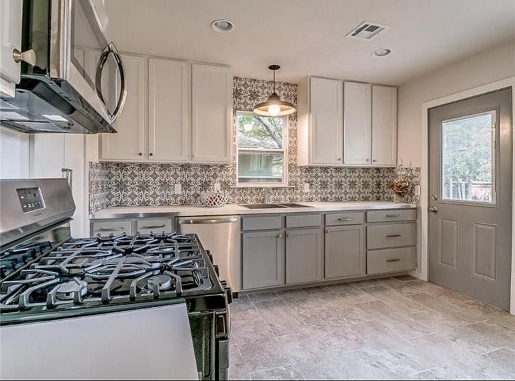 Completely renovated modern kitchen. All new stainless appliances including microwave. (New refrigerator with ice-maker not shown.) Open floor plan to dining & living.